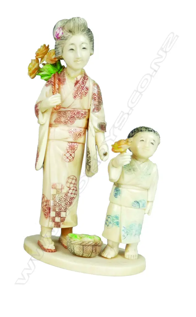 A Japanese carved ivory figure group of a mother and child Image 1++