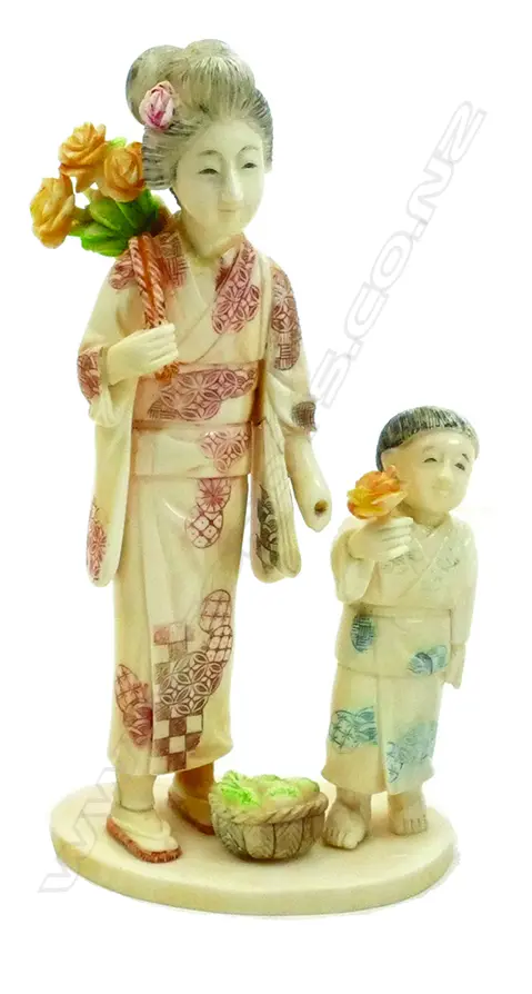 A Japanese carved ivory figure group of a mother and child Image 1++