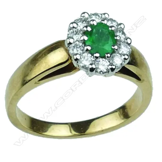 A lady's estate 9ct. yellow and white gold emerald and diamond ring