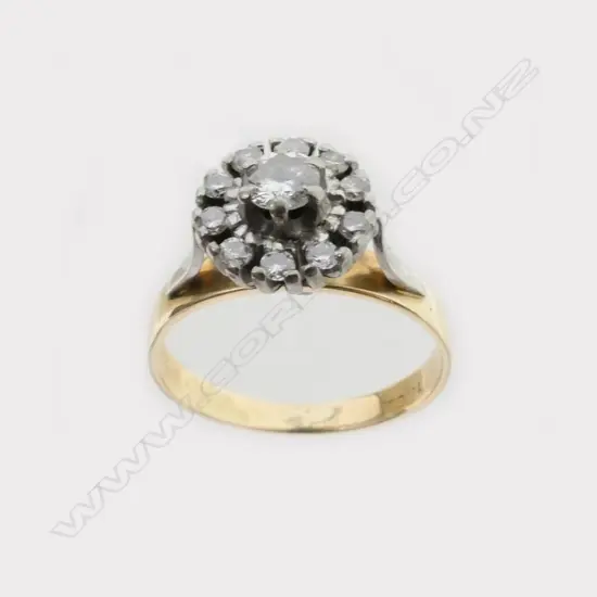 An 18ct. yellow and white gold diamond cluster ring