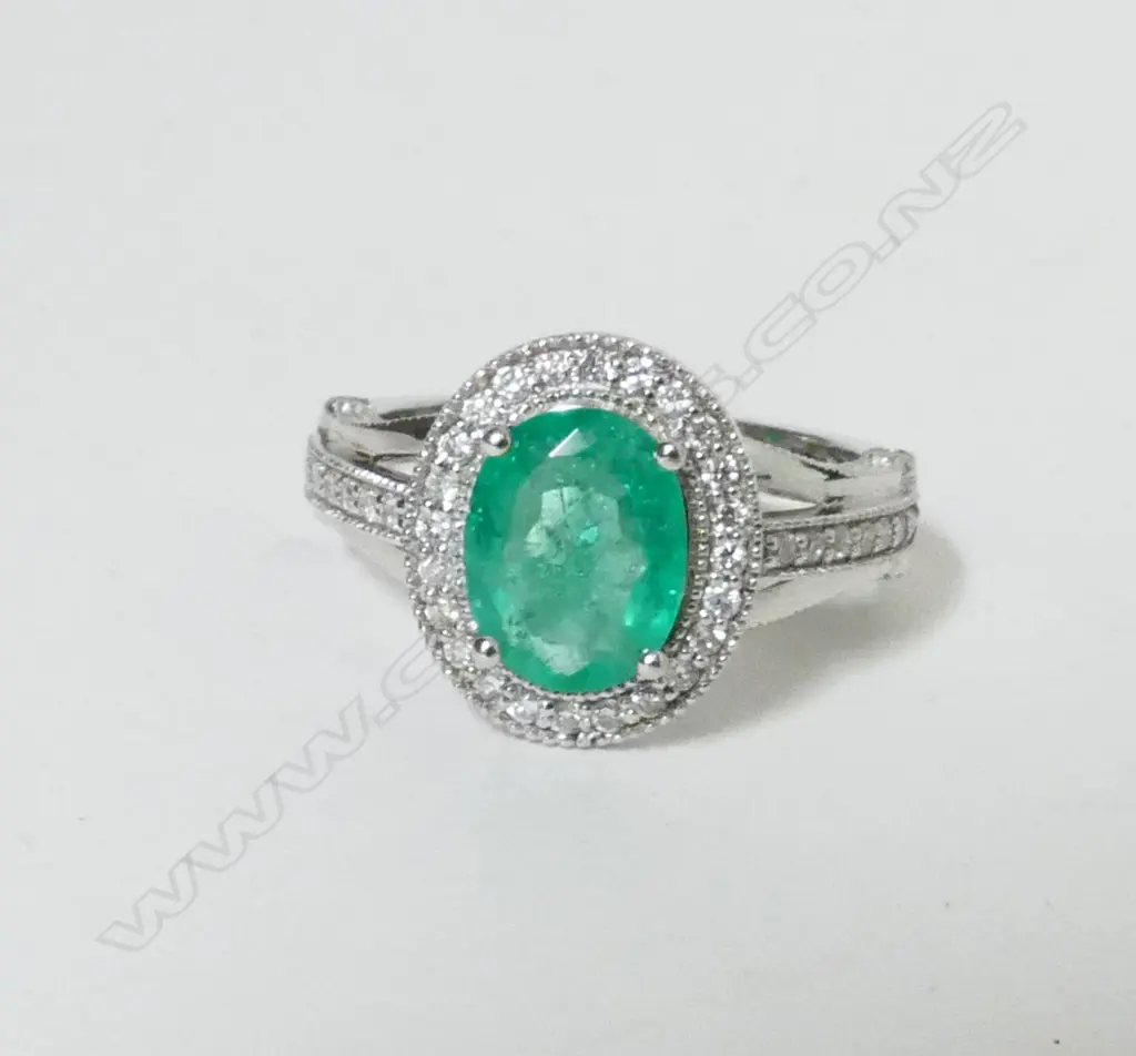 An 18ct. white gold emerald and diamond ring Image 1++