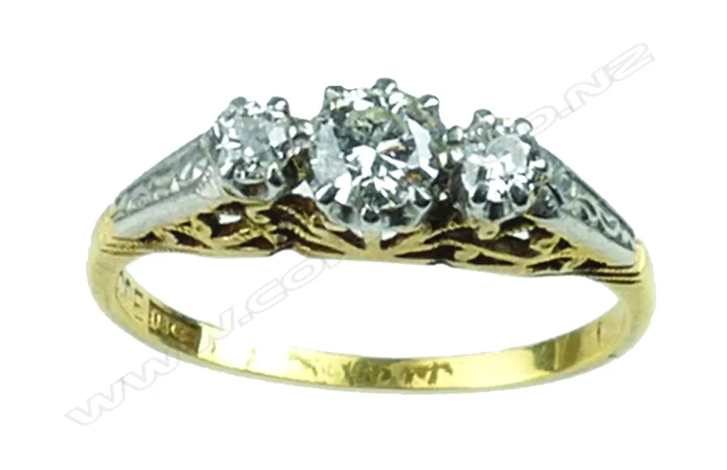 An 18ct. gold three stone diamond ring Image 1++