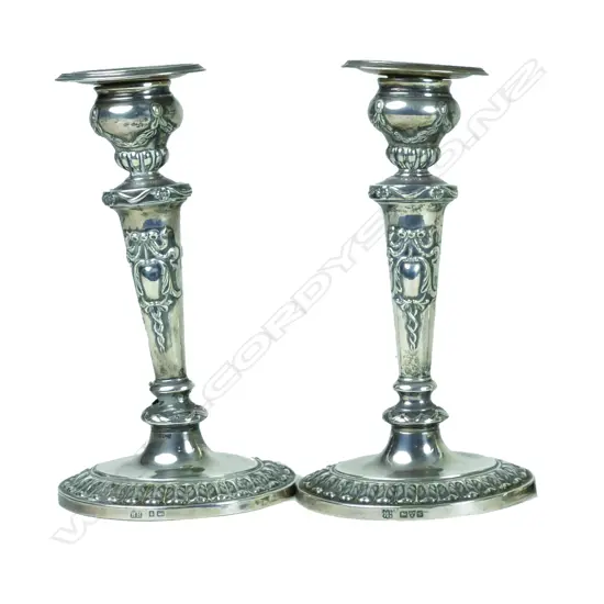 A pair of small Edwardian period silver candlesticks