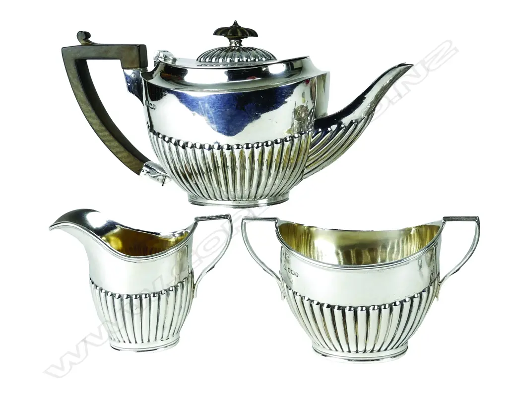 A silver Georgian Revival three-piece bachelor's tea set Image 1++
