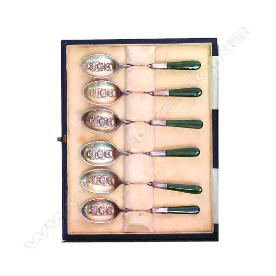 A set of silver teaspoons decorated with Maori motifs and greenstone handles