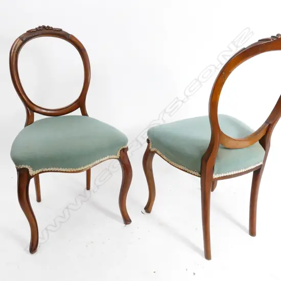 A set of six Victorian walnut balloon back dining chairs