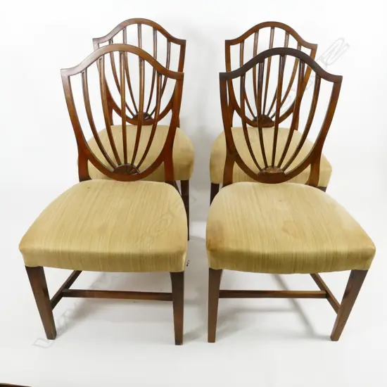 A set of four Hepplewhite-style walnut dining chairs