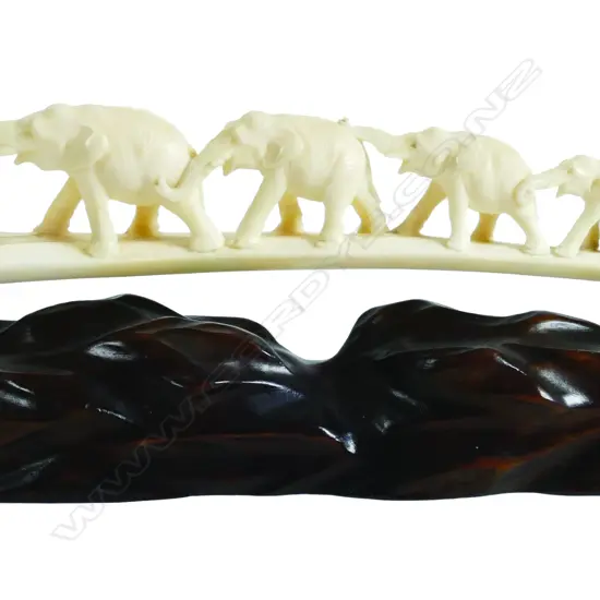 An old carved ivory tusk elephant bridge