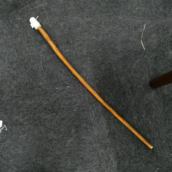 A carved antler handled wooden walking stick