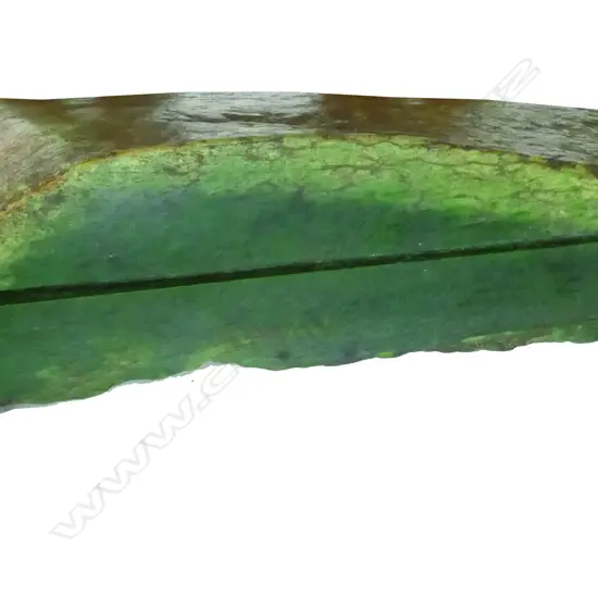 A wedge shaped slab of high quality pounamu (nephrite)