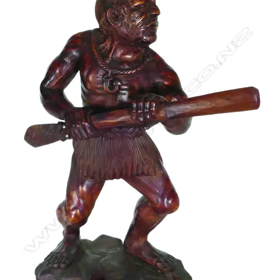 A carved kauri third size sculpture of a Maori warrior