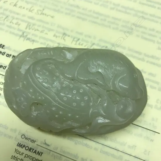 A Chinese pale jade handling piece
