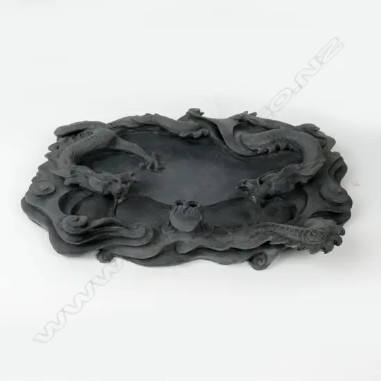 A Chinese highly carved deep relief black ink stone