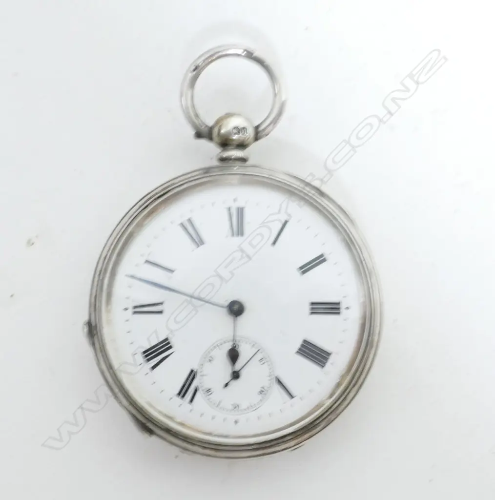 A silver pocket watch Image 1++