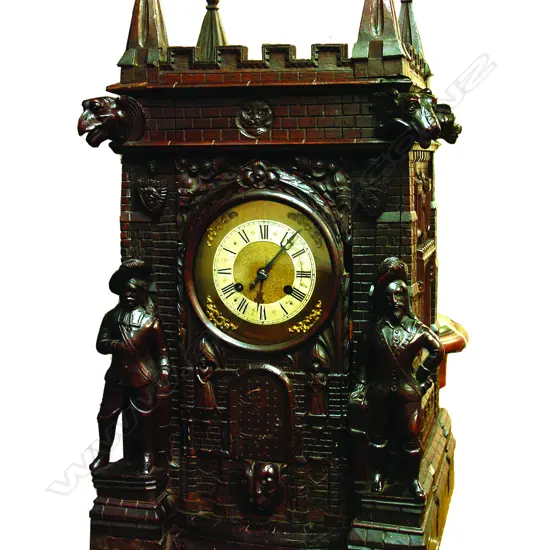 A late 19thC large carved oak castle cased mantel clock
