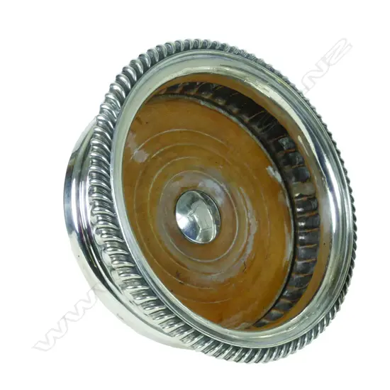 An uncommon George IV silver bottle coaster