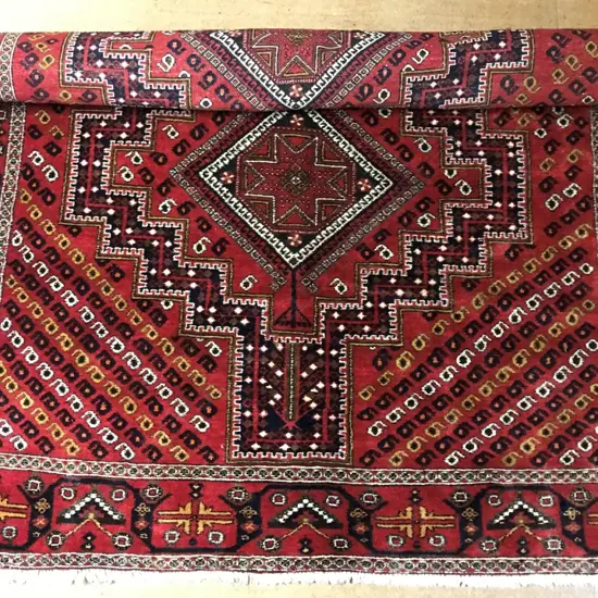 A hand knotted Persian Shiraz tribal rug