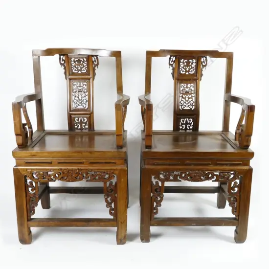 A pair of Chinese teak Emperor and Empress open elbow chairs
