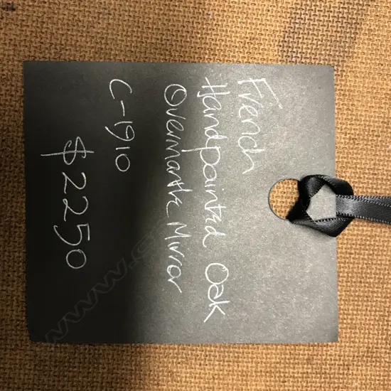 A late 19thC oak overmantel mirror with painted panel