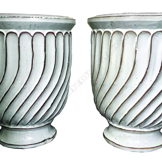 A pair of very large white glazed garden urns