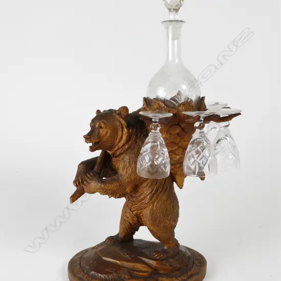 A Black Forest carved decanter stand