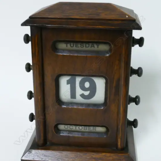 An Edwardian oak-cased perpetual calendar