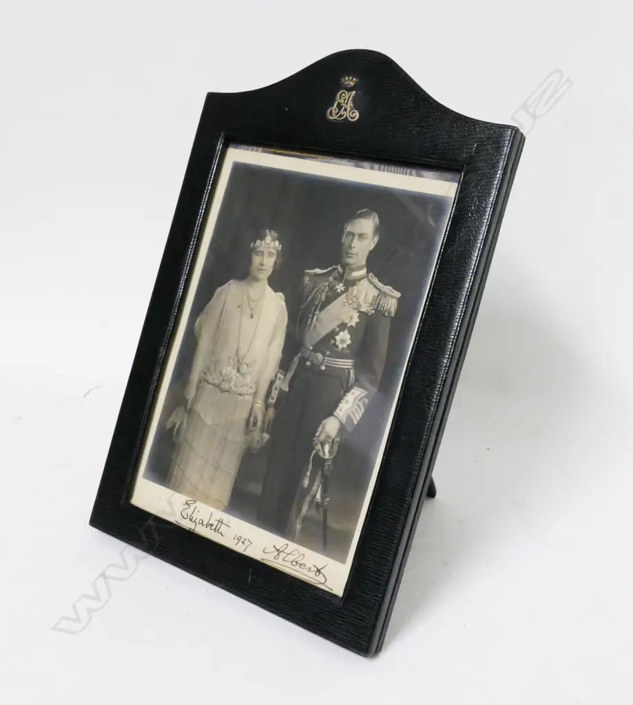 A vintage leather photo frame holding a signed photograph of King George VI and Queen Elizabeth II Image 1++