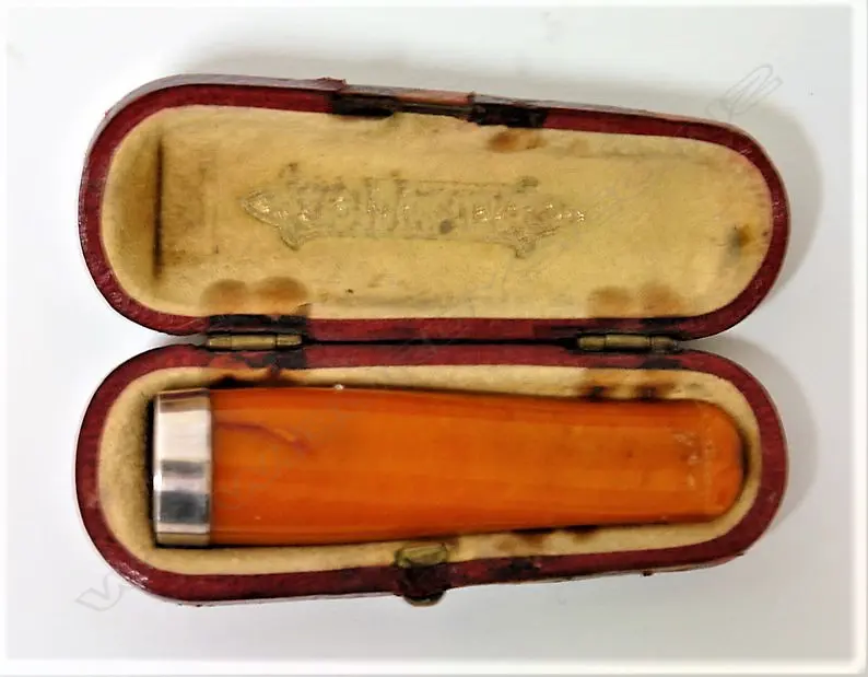 An early 20thC amber and silver cigarette holder Image 1++