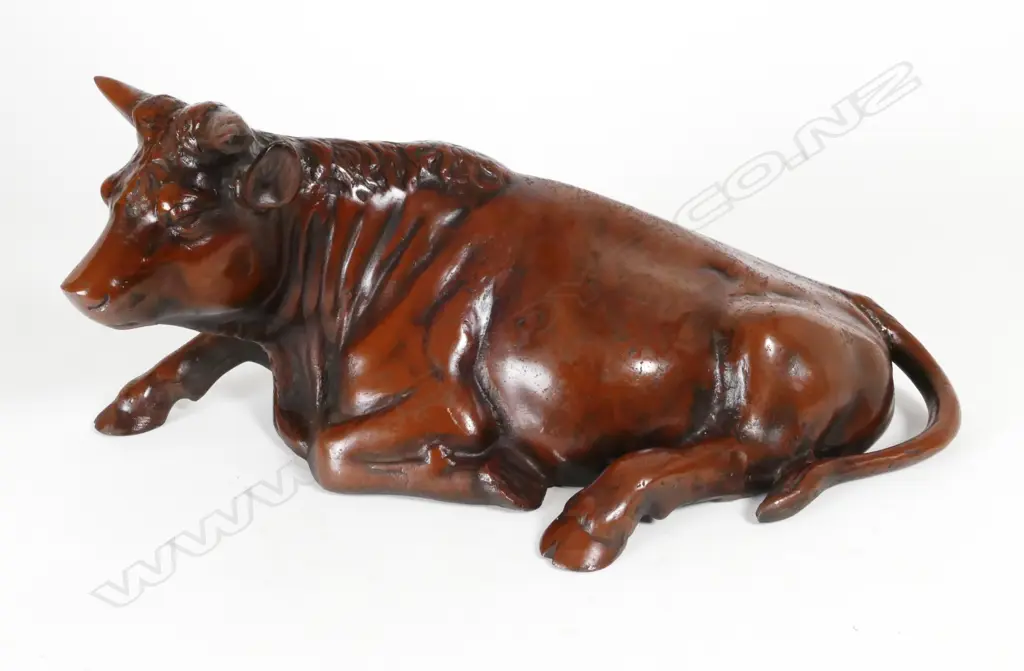 A cast iron model of a recumbent bull Image 1++
