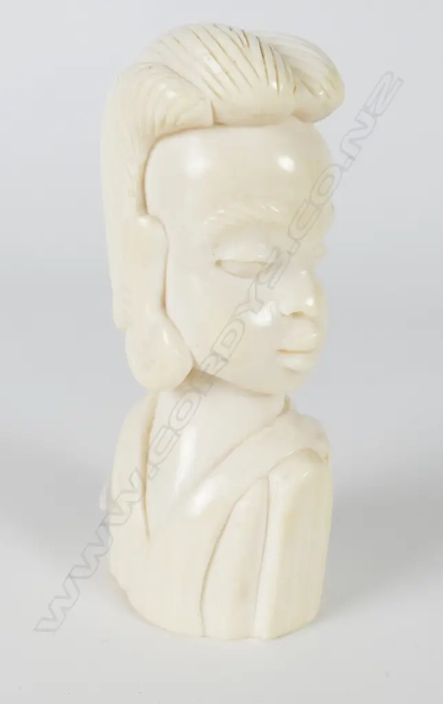 A small solid carved ivory bust of an African woman Image 1++