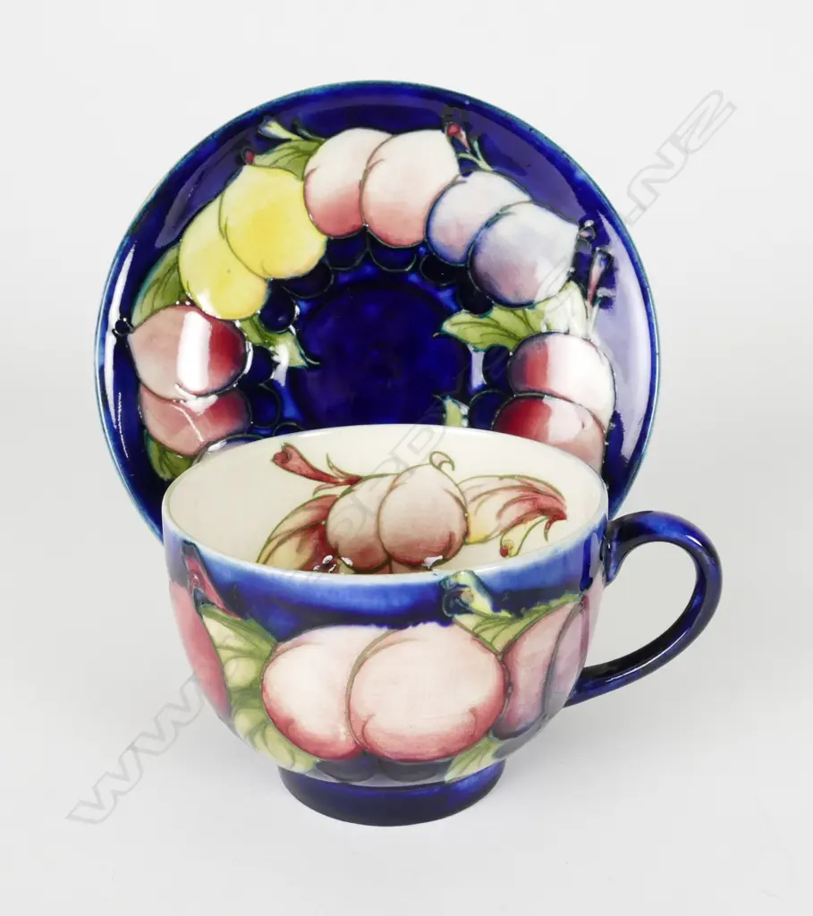 A William Moorcroft Wisteria pattern tea cup and saucer Image 1++