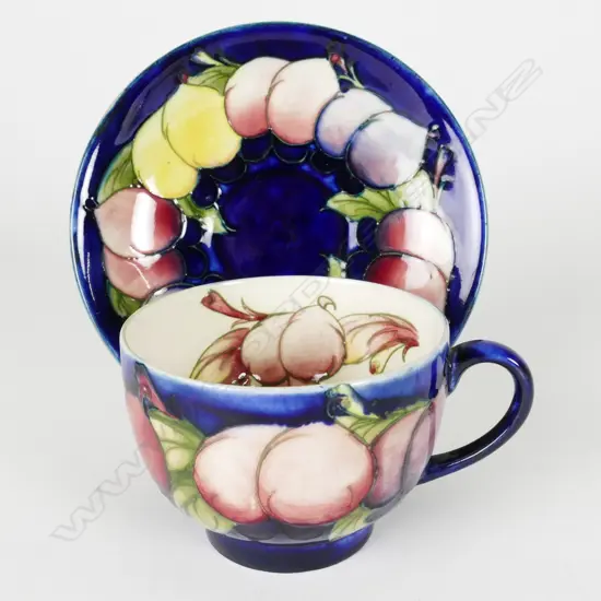 A William Moorcroft Wisteria pattern tea cup and saucer