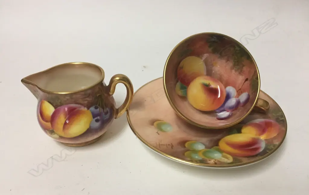 A Royal Worcester hand painted cup and saucer and miniature jug Image 1++