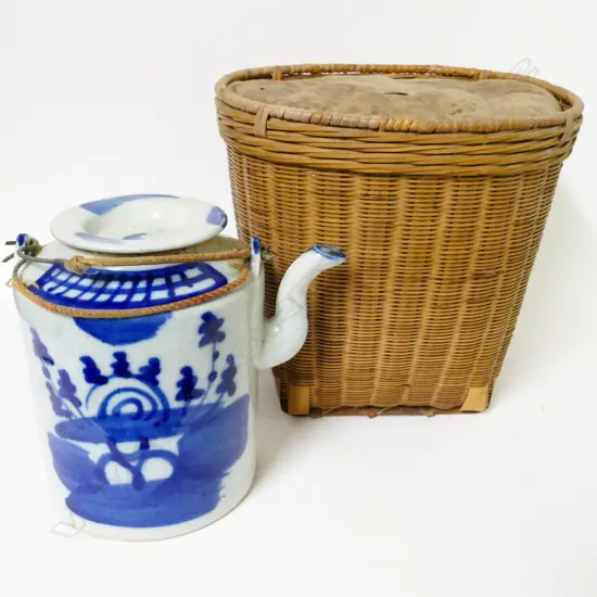 An early 1900s Chinese tea kettle in basket
