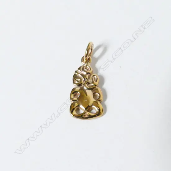 A vintage 9ct. gold tiki pendant charm