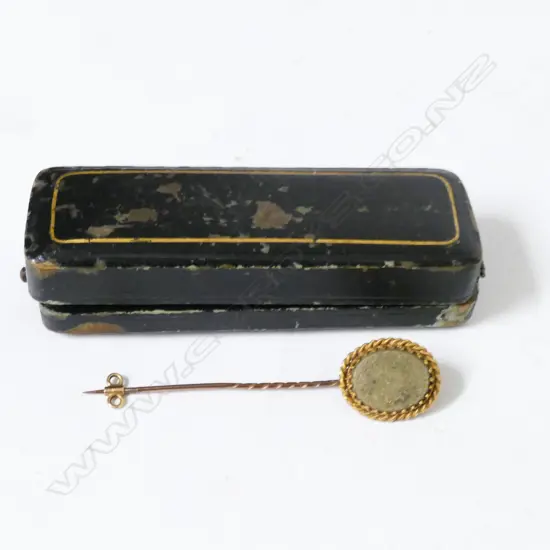 An antique gold stick pin