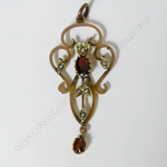 An Edwardian 9ct. gold garnet and pearl pendant