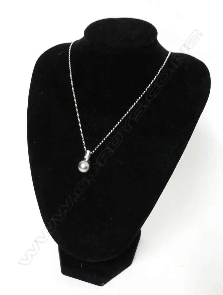 A 14ct. white gold black pearl and diamond pendant Image 1++