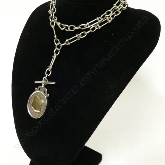 An antique silver fob chain and medal