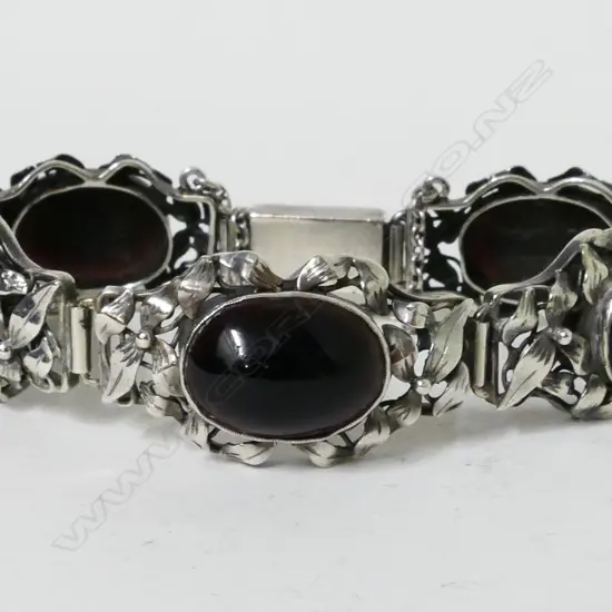 An early 20thC Arts & Crafts style silver and garnet? bracelet