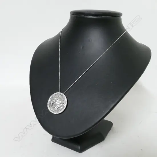 A modern 18ct. white gold and diamond set pendant on chain