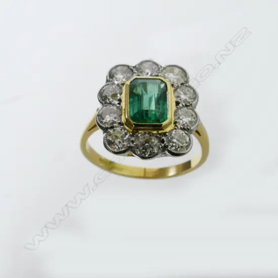 An 18ct yellow gold emerald and diamond ring