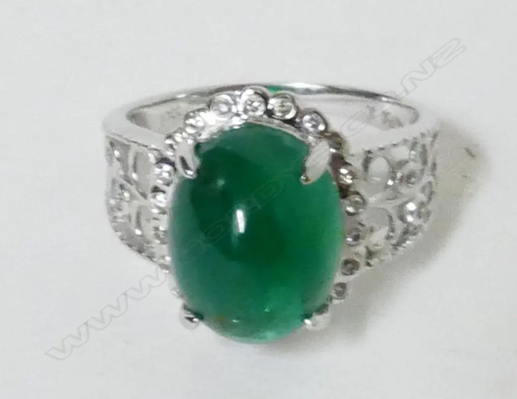 An 18ct. white gold emerald and diamond ladies dress ring Image 1++