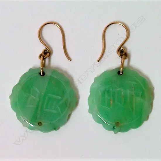 A pair of Chinese green jade and 9ct. earrings