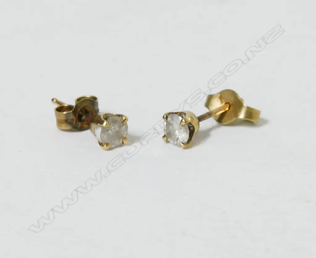 A pair of 9ct gold and diamond stud earrings Image 1++
