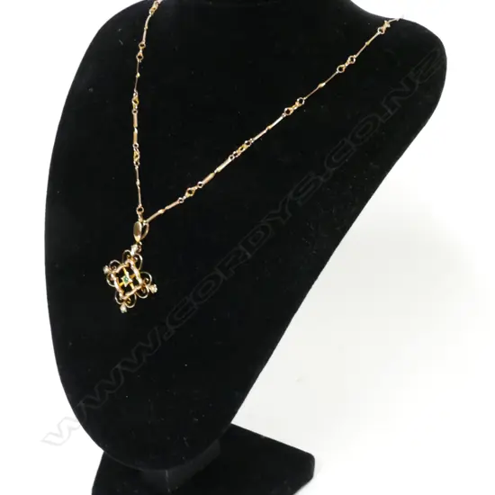 A 9ct. greenstone and seed pearl pendant