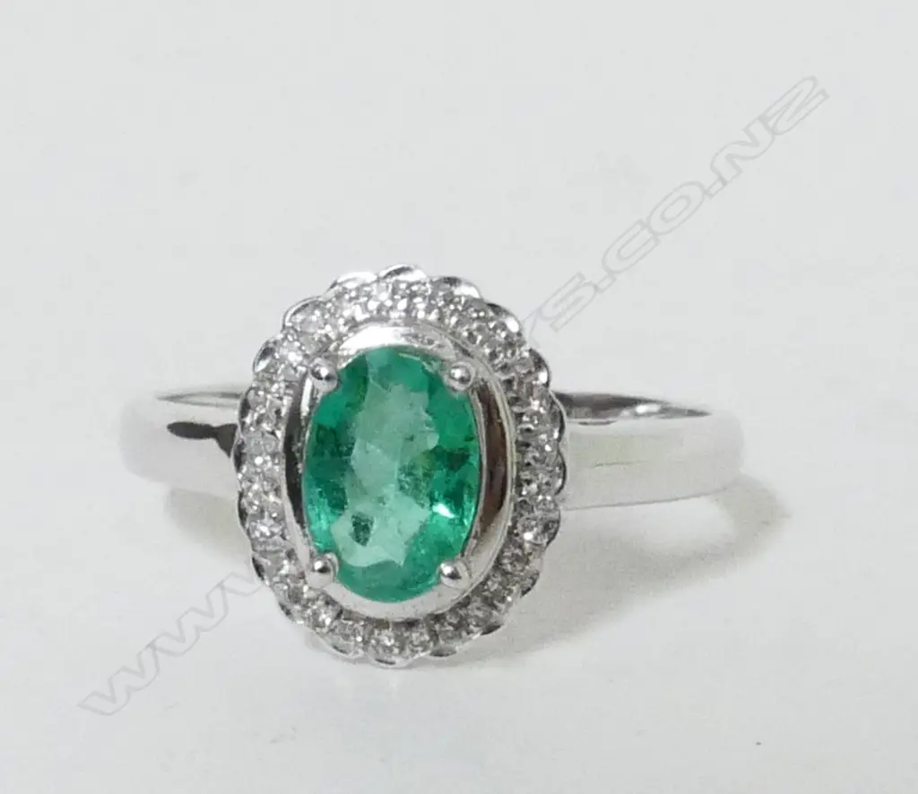 An 18ct. white gold emerald and diamond dress ring Image 1++