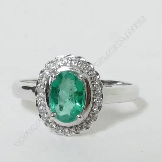 An 18ct. white gold emerald and diamond dress ring