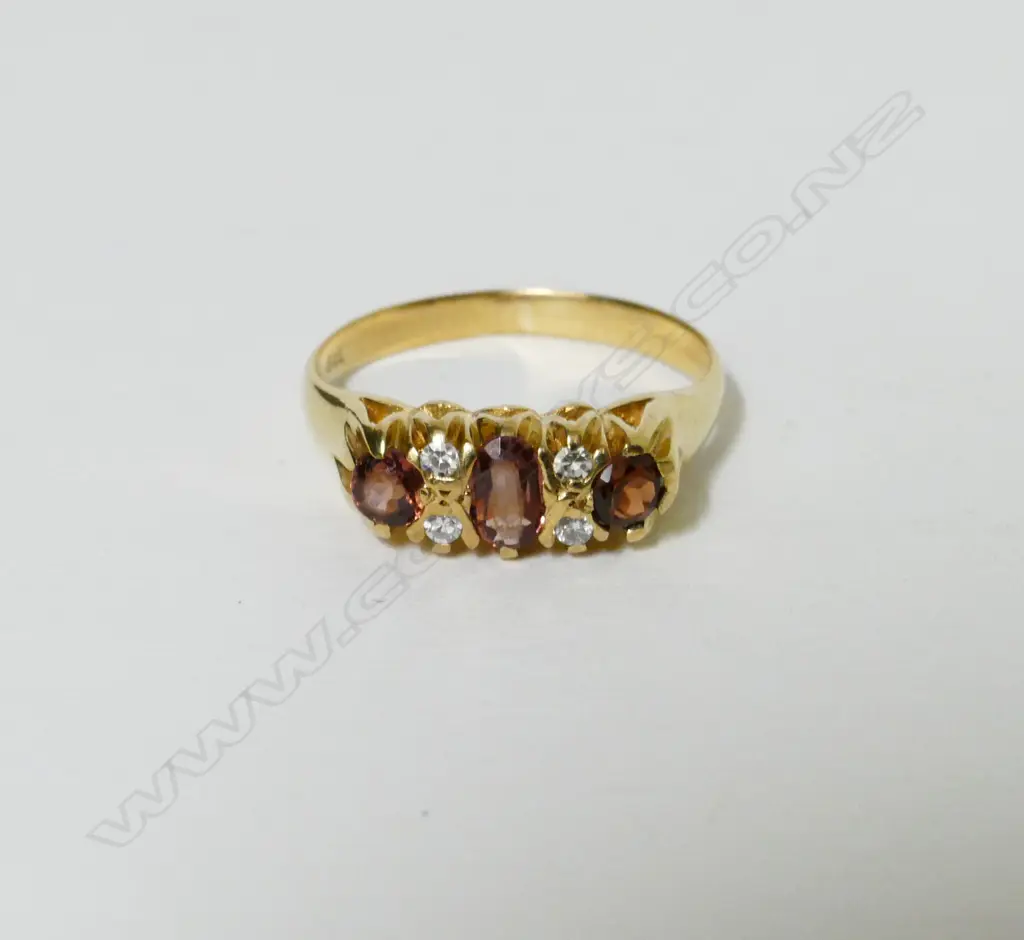 A 9ct. gold garnet and diamond ring Image 1++