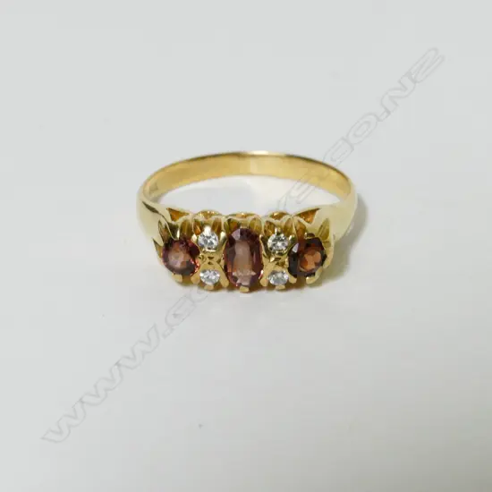 A 9ct. gold garnet and diamond ring